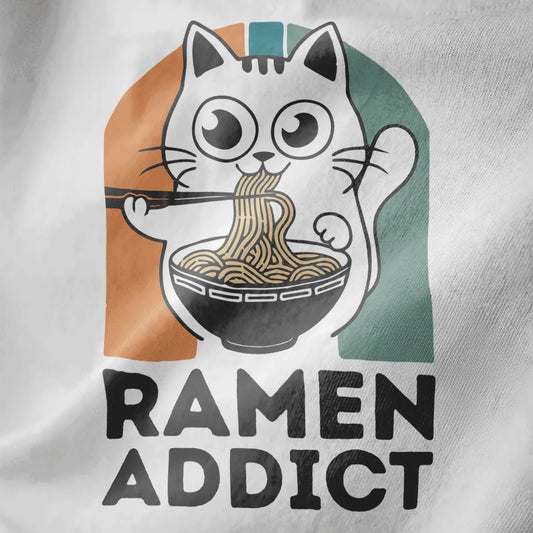 White fabric close-up of a playful cat slurping ramen, bold "RAMEN ADDICT" text below, kawaii clothes, ramen t-shirt.