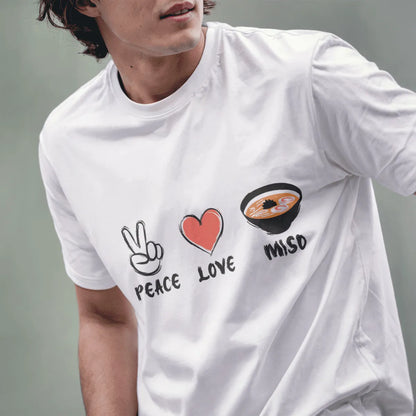 Male model in white t-shirt displaying Peace, Love, Miso design with hand-drawn icons celebrating Japanese culture.