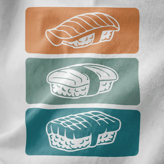 Close-up of vibrant sushi trio design on white shirt, featuring colorful backgrounds and modern fusion style.